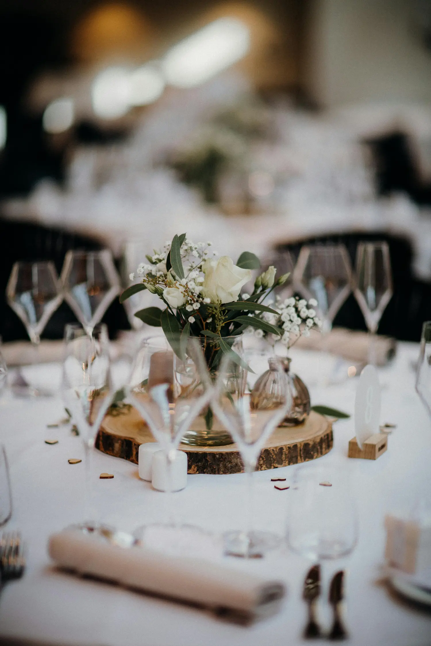 Elegant candlelit dinner table with a floral centerpiece.