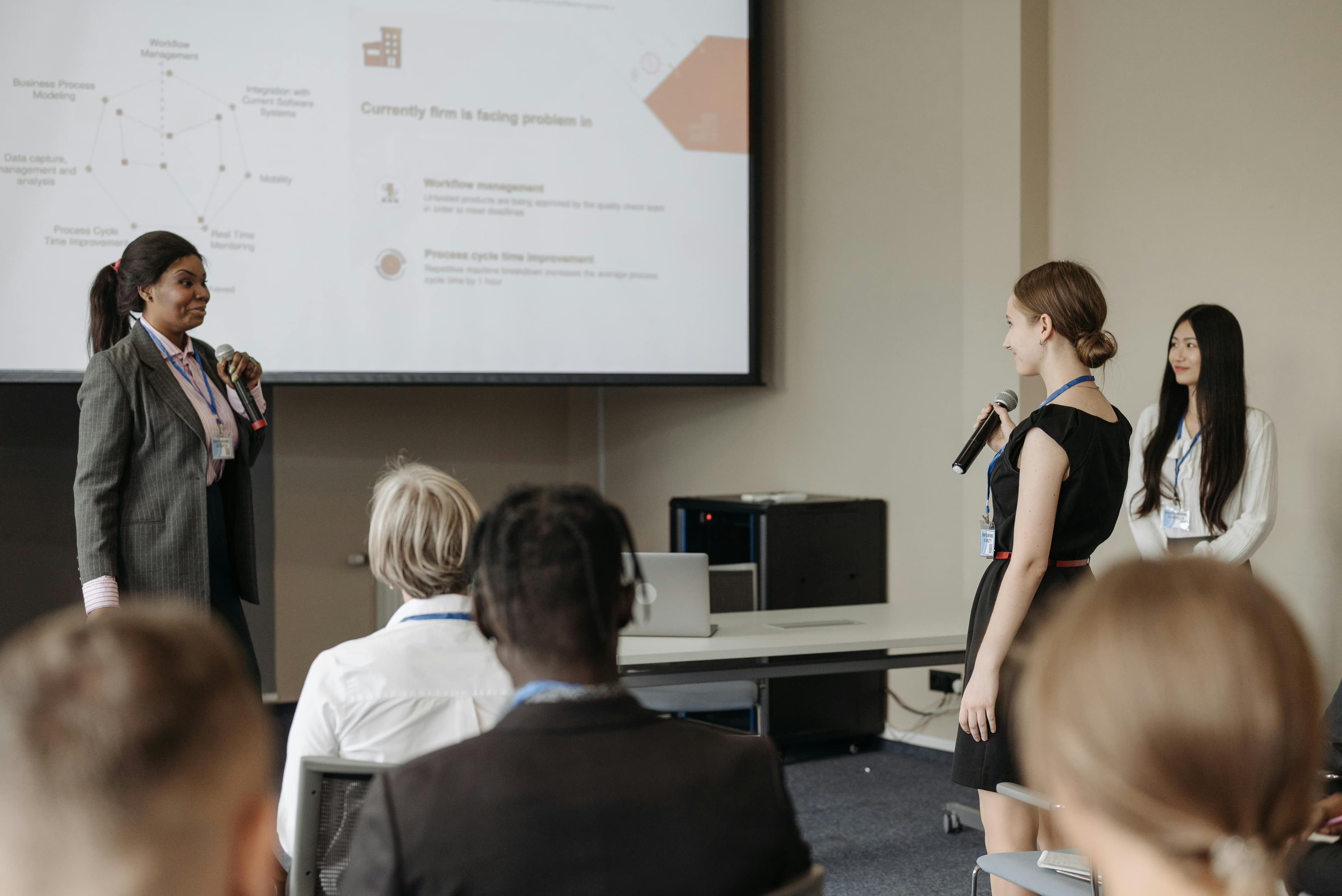 Business conference with presenters and engaged audience in a modern venue.